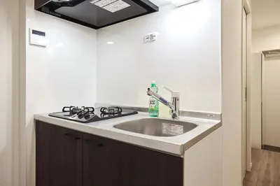 a kitchen with a sink and a stove at THE Dorchester β in Tokyo