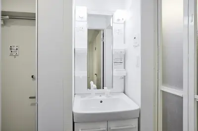 a white bathroom with a sink and a mirror at THE Dorchester β in Tokyo