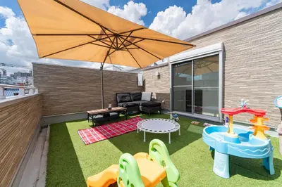 a patio with a table and an umbrella at KR family terrace in Tokyo