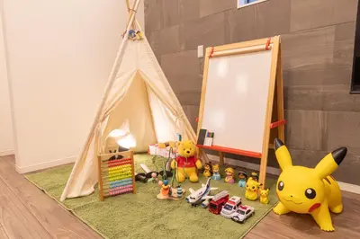 a room with a teepee tent with toys on a rug at KR family terrace in Tokyo