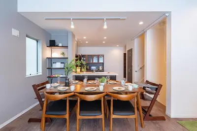 a dining room with a wooden table and chairs at KR family terrace in Tokyo