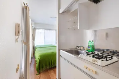 a kitchen with a sink and a kitchen with a bed at \u30a2\u30b9\u30d4\u30a2403 in Tokyo