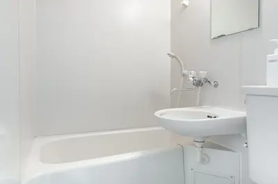 a white bathroom with a sink and a bath tub at \u30a2\u30b9\u30d4\u30a2403 in Tokyo