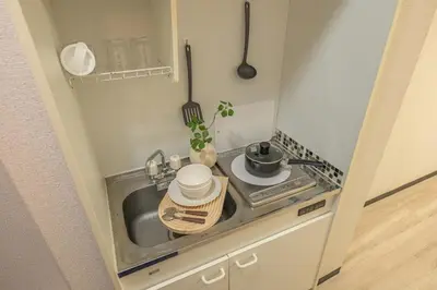 a small kitchen with a sink and a stove at Near Shinjuku Nakano unit walking 4mins Broadway in Tokyo
