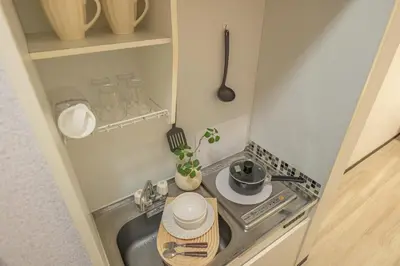 a small kitchen with a sink and a stove at Near Shinjuku Nakano unit walking 4mins Broadway in Tokyo