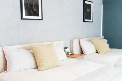 two beds in a room with white pillows and a table at Yy-\u7be0\u516c\u5bd33LDK-TS0376 in Tokyo
