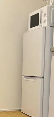 a white refrigerator with a microwave on top of it at The Bella Ueno in Tokyo