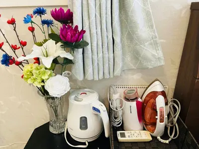 a table with a vase of flowers and appliances at The Bella Ueno in Tokyo