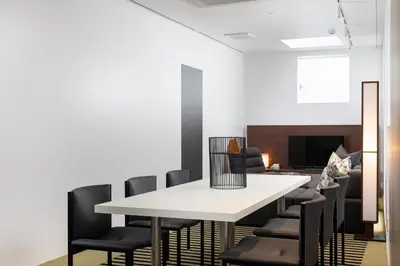 a dining room with a white table and black chairs at JAPAVISTA r4 in Tokyo