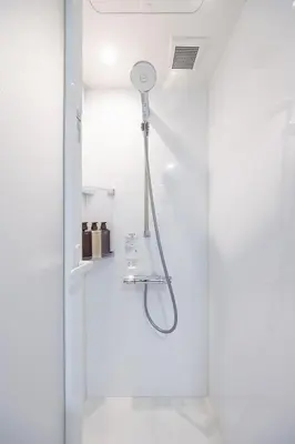 a shower with a shower head in a bathroom at JAPAVISTA r4 in Tokyo
