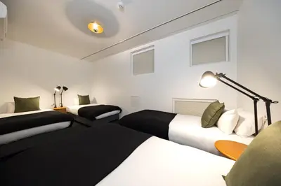 a hotel room with two beds and a lamp at JAPAVISTA r4 in Tokyo