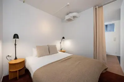 a white bedroom with a bed and a window at JAPAVISTA r4 in Tokyo