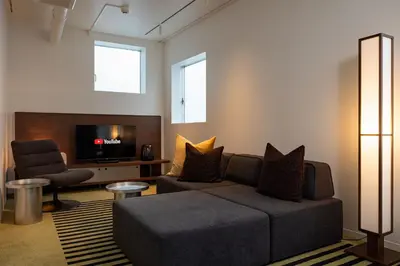 a living room with a couch and a tv at JAPAVISTA r4 in Tokyo