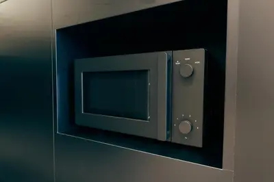 a microwave oven on a wall in a room at illi Lay Shibuya-Ebisu in Tokyo