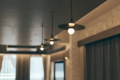 three lights hanging from a ceiling in a room at illi Lay Shibuya-Ebisu in Tokyo