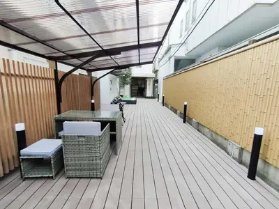 a hallway with a table and chairs in a building at C2 Shinjuku JR St 8 mins 2 bedrooms and 1 living room Max 5P Direct to Shinjuku Ueno Ginza Shibuya Ikebukuro Yoyogi Shinagawa \u65b0\u5bbf\u533a \u9ad8\u7530\u9a6c\u573a\u8f66\u7ad98\u5206\u949f \u4e24\u5ba4\u4e00\u5385 \u6700\u59275\u4eba in Tokyo