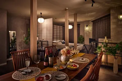 a dining room with a wooden table with food on it at Nihonbashi Hamacho Hotel Fortuna, PH 50m2, 3min, 4pax in Tokyo