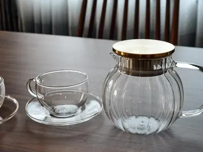 a glass jug and a cup on a wooden table at Nihonbashi Hamacho Hotel Fortuna, PH 50m2, 3min, 4pax in Tokyo