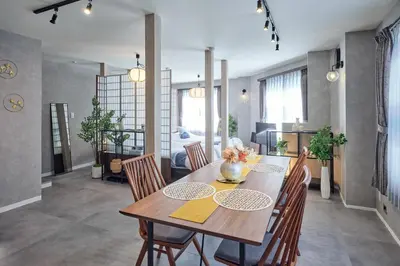 a dining room with a wooden table and chairs at Nihonbashi Hamacho Hotel Fortuna, PH 50m2, 3min, 4pax in Tokyo