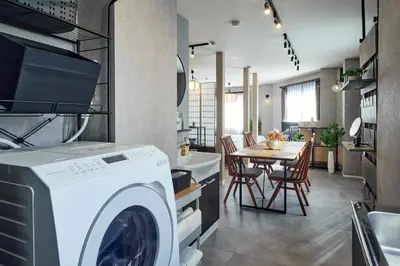 a kitchen with a washing machine and a dining room at Nihonbashi Hamacho Hotel Fortuna, PH 50m2, 3min, 4pax in Tokyo