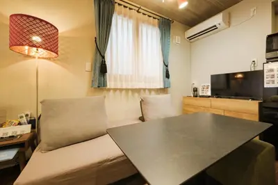 a living room with a table and a couch at GOOD DAY Shinagawa HOTEL in Tokyo