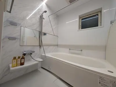 a white bathroom with a tub and a sink at \u6c60\u888b\u672c\u753a101 in Tokyo