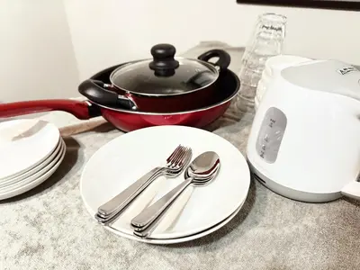 a table with plates and utensils and a pot at \u6c60\u888b\u672c\u753a101 in Tokyo