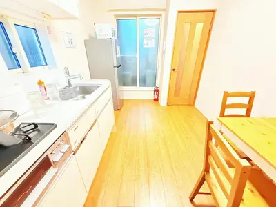 a kitchen with a sink and a refrigerator at \u6c60\u888b\u672c\u753a101 in Tokyo