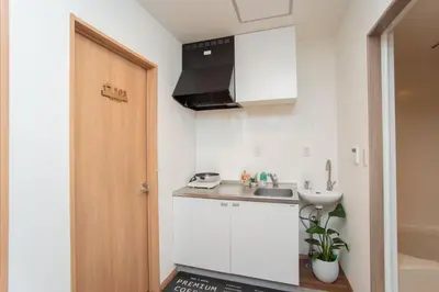 a small kitchen with a sink and a counter at Natsumi \u30db\u30c6\u30eb 2F \u6210\u7530\u673a\u573a-\u7fbd\u7530\u673a\u573a-\u4e0a\u91ce \u4e00\u7ebf\u76f4\u8fbe in Tokyo