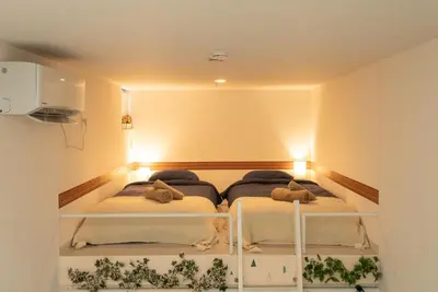 two beds in a room with lights on at Designer condo close to Asakusa, Tokyo Skytree in Tokyo