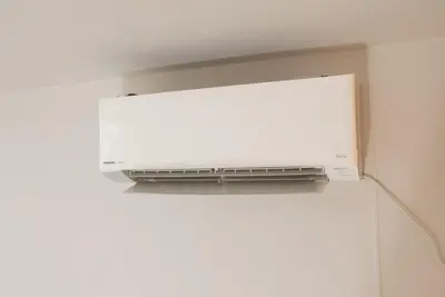 a microwave oven hanging on the side of a wall at Designer condo close to Asakusa, Tokyo Skytree in Tokyo