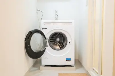 a washing machine in a corner of a room at Designer condo close to Asakusa, Tokyo Skytree in Tokyo