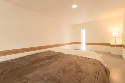 a bedroom with a large bed with a window at Designer condo close to Asakusa, Tokyo Skytree in Tokyo