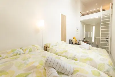 two beds sitting next to each other in a bedroom at Designer condo close to Asakusa, Tokyo Skytree in Tokyo