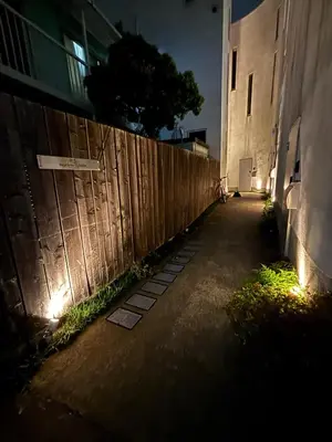 a dark alley with a fence and a building at Designer condo close to Asakusa, Tokyo Skytree in Tokyo