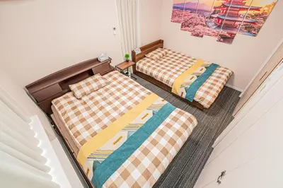 two beds sitting next to each other in a room at Private 3 Bedroom House with Free Parking Near Asakusa and Skytree in Tokyo