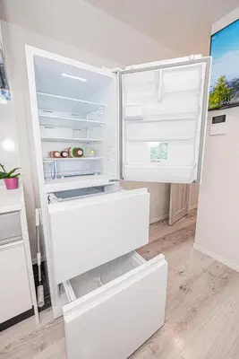 a white refrigerator with its door open in a kitchen at Private 3 Bedroom House with Free Parking Near Asakusa and Skytree in Tokyo