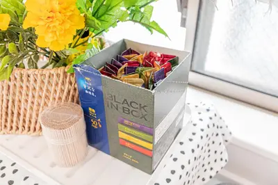 a box of candy on a table next to a vase at Private 3 Bedroom House with Free Parking Near Asakusa and Skytree in Tokyo