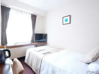 a hotel room with a bed and a tv at POD SELECT HOTEL SHINJUKU - Vacation STAY 43667v in Tokyo