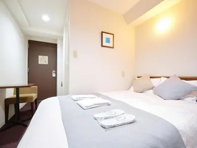 a hotel room with a bed with towels on it at POD SELECT HOTEL SHINJUKU - Vacation STAY 43664v in Tokyo
