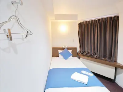 a small room with a bed with a window at POD SELECT HOTEL SHINJUKU - Vacation STAY 43665v in Tokyo