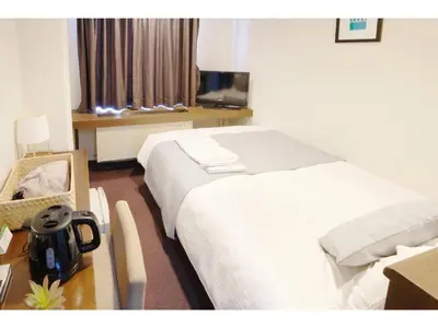a hotel room with two beds and a table at POD SELECT HOTEL SHINJUKU - Vacation STAY 43662v in Tokyo