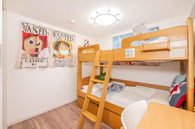 a bedroom with two bunk beds and a table at Stay cozy - Vacation STAY 43532v in Tokyo
