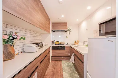 a kitchen with wooden cabinets and a white refrigerator at Stay cozy - Vacation STAY 43532v in Tokyo