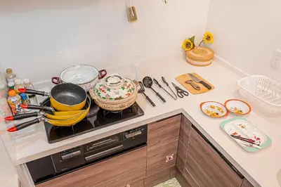 a kitchen counter with a stove with pots and pans at Stay cozy - Vacation STAY 43532v in Tokyo