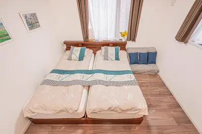 two beds in a room with a window at Stay cozy - Vacation STAY 43532v in Tokyo