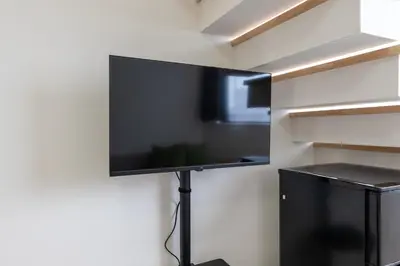 a flat screen tv hanging on a wall at Hotel Yoyogi Uehara Tokyo in Tokyo