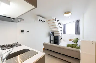 a kitchen and living room with a couch in a room at Hotel Yoyogi Uehara Tokyo in Tokyo