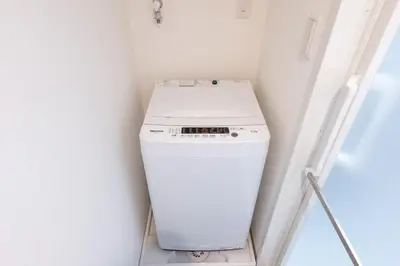a washer and dryer in a white room at Hotel Yoyogi Uehara Tokyo in Tokyo