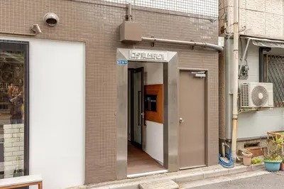 a door to a building with a sign on it at rot\u6771\u4e0a\u91ce3\u4e01\u76ee301 in Tokyo